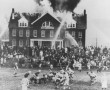 A high school football game continues as a fire rages on at a school in Northfield, Massachusetts1965